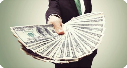 Person holding a fan of US dollar bills"